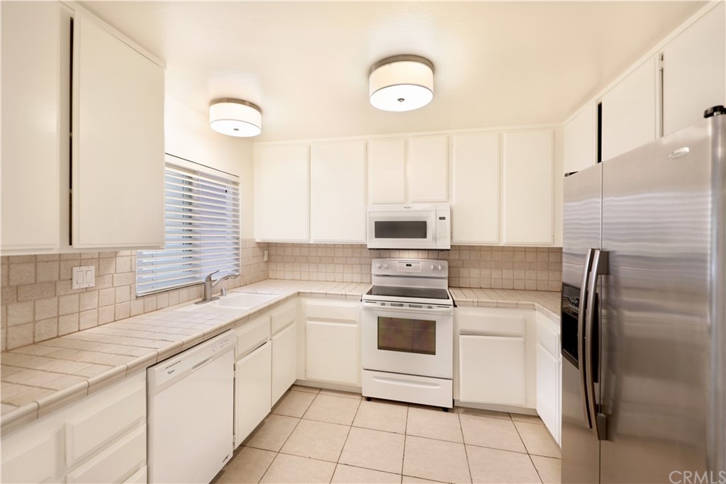 34004 Selva Road, Unit 377 Dana Point, CA 92629 - Photo 5 of 19 a kitchen with a sink cabinets and stainless steel appliances