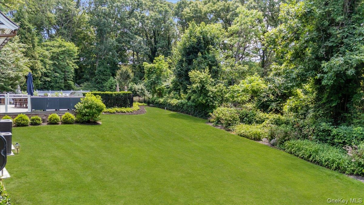 5 Fox Hunt Court Cold Spring Harbor, NY 11724 - Photo 36 of 42 Expansive green lawn surrounded by mature trees and varied foliage