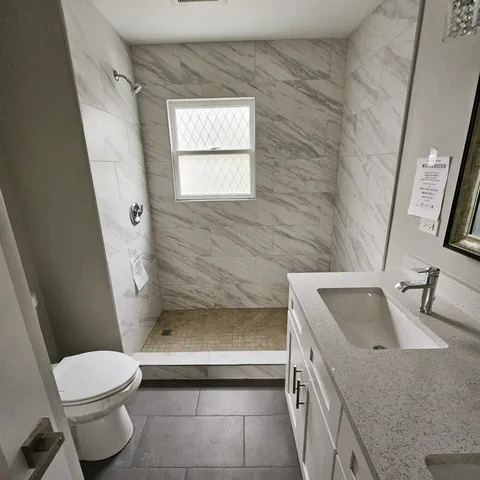 a bathroom with a sink a toilet and tub