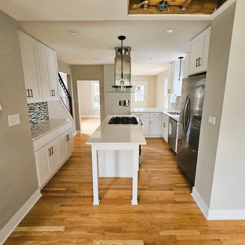a dining room with wooden floor and stairs