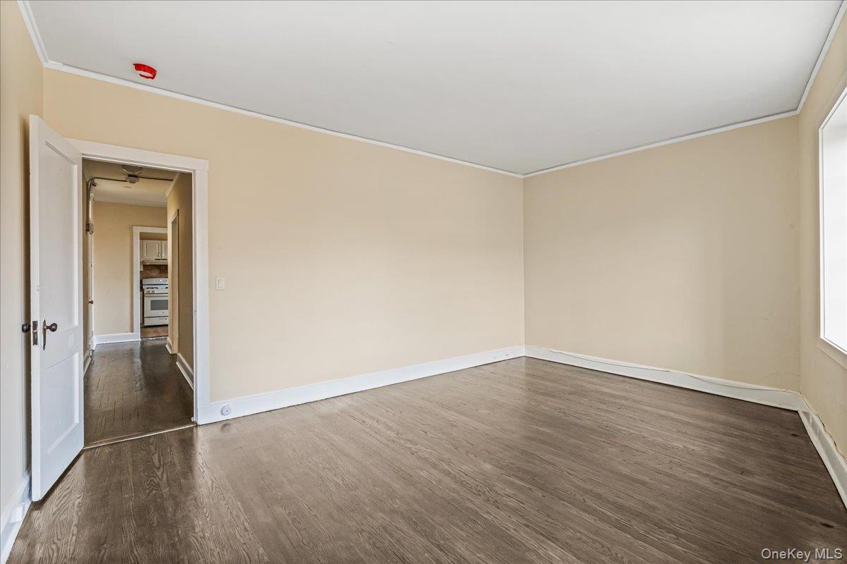 409 Plandome Road, Unit H Manhasset, NY 11030 - Photo 11 of 15 an empty room with wooden floor and closet