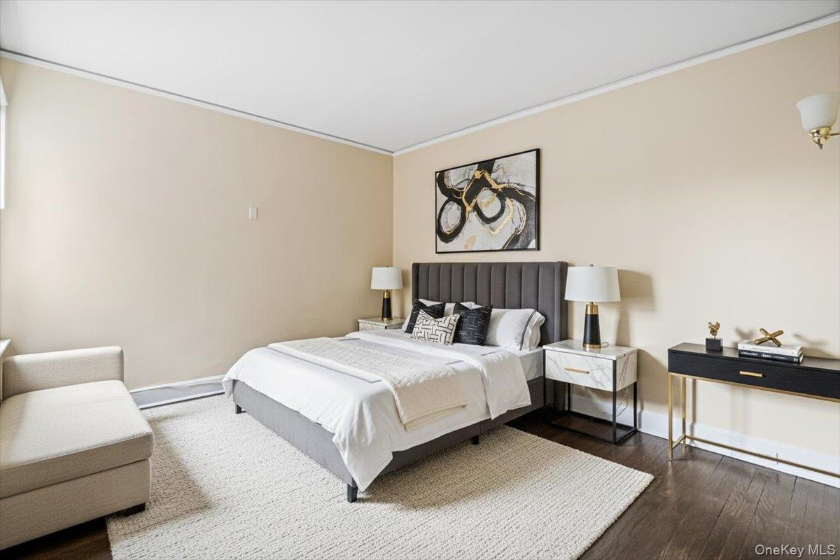 409 Plandome Road, Unit H Manhasset, NY 11030 - Photo 12 of 15 a bedroom with a bed and a couch