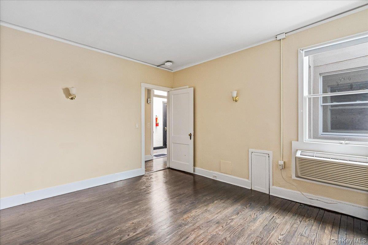409 Plandome Road, Unit H Manhasset, NY 11030 - Photo 13 of 15 a view of empty room with wooden floor and fan