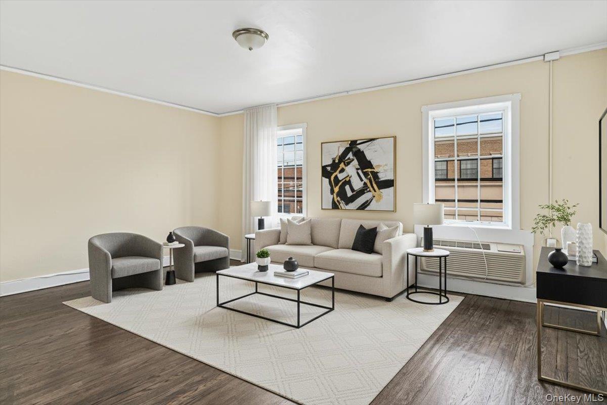 409 Plandome Road, Unit H Manhasset, NY 11030 - Photo 3 of 15 a living room with furniture and windows