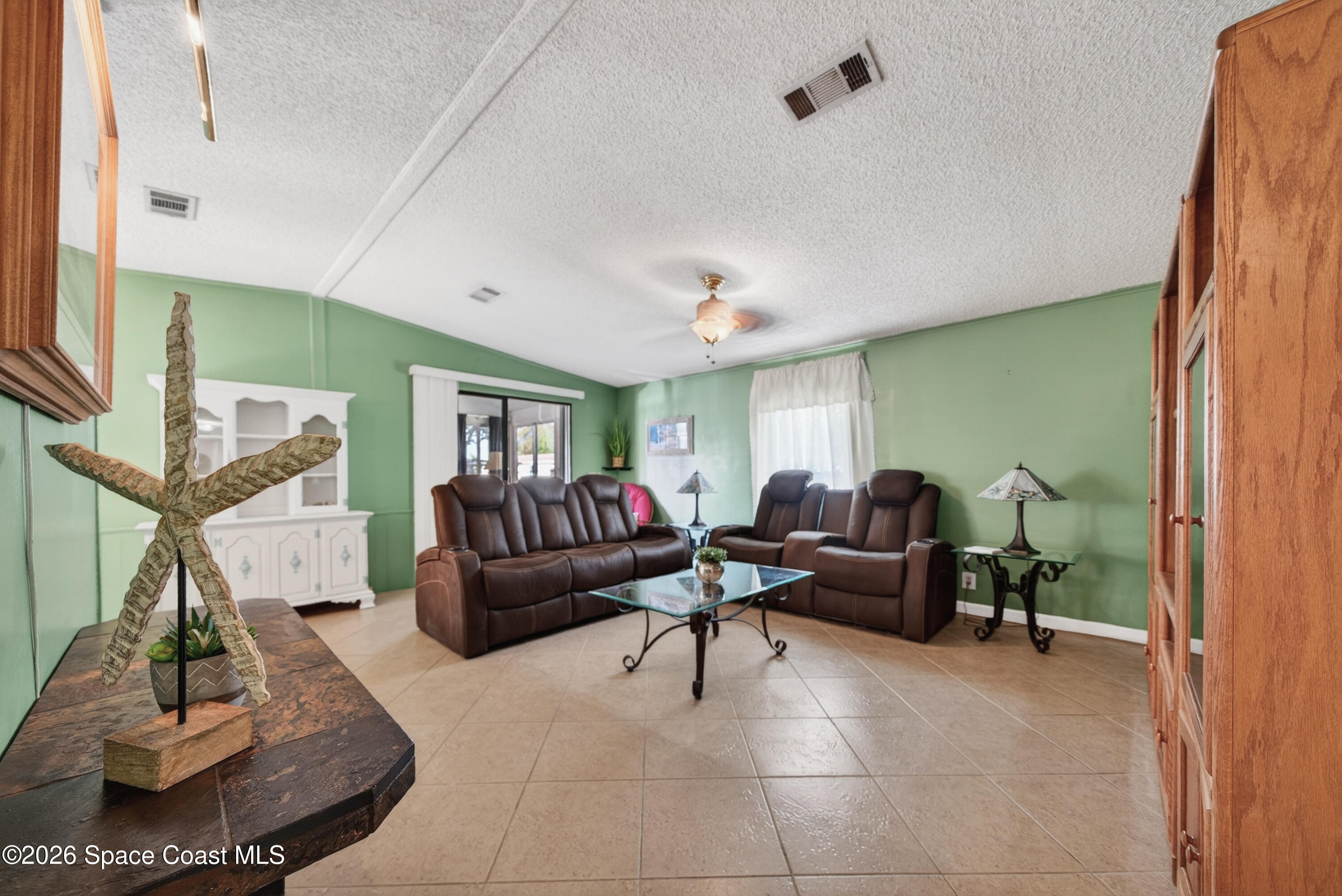 7645 Chasta Road Micco, FL 32976 - Photo 14 of 39 a living room with furniture and a flat screen tv