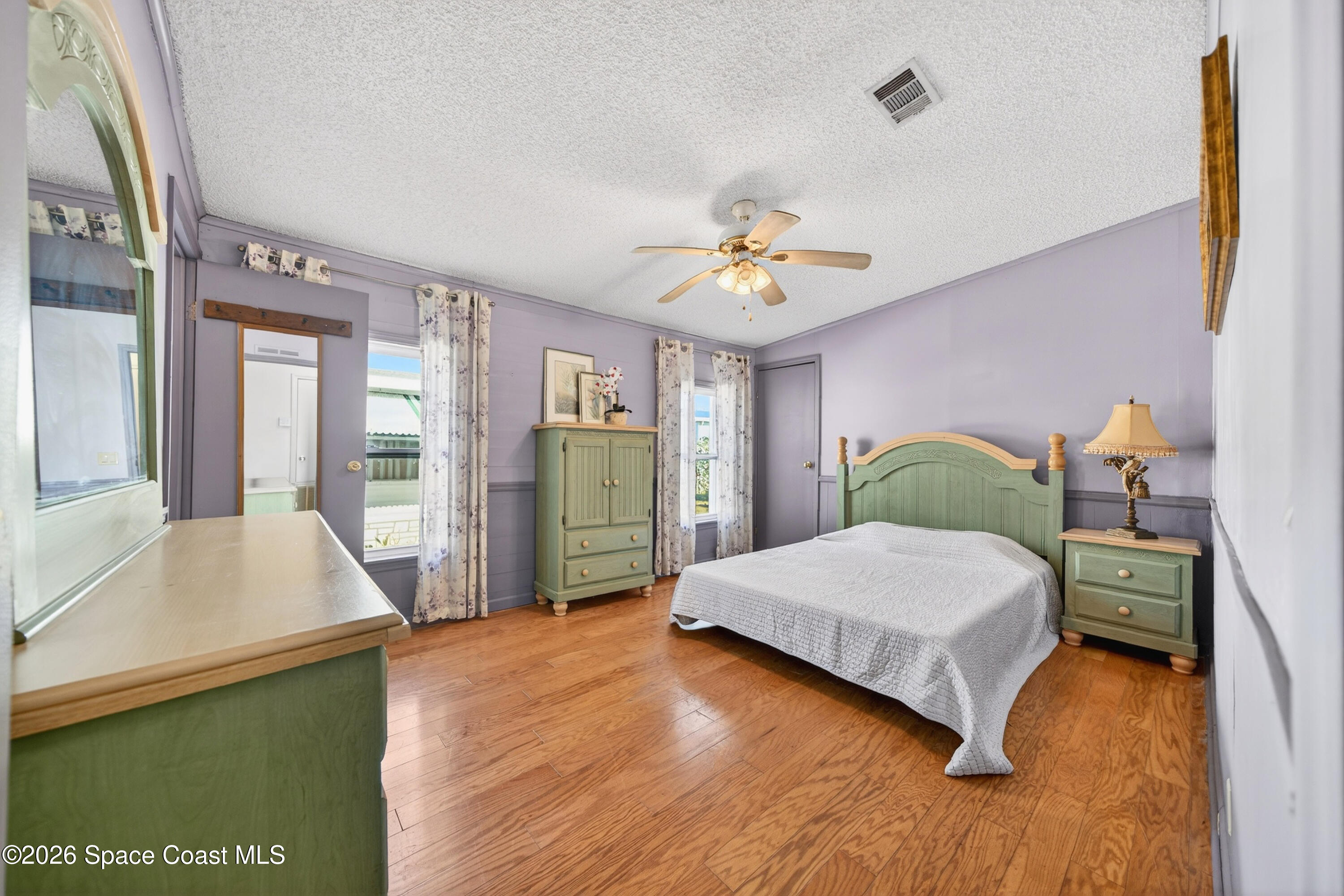 7645 Chasta Road Micco, FL 32976 - Photo 16 of 39 a bedroom with a bed and a chandelier