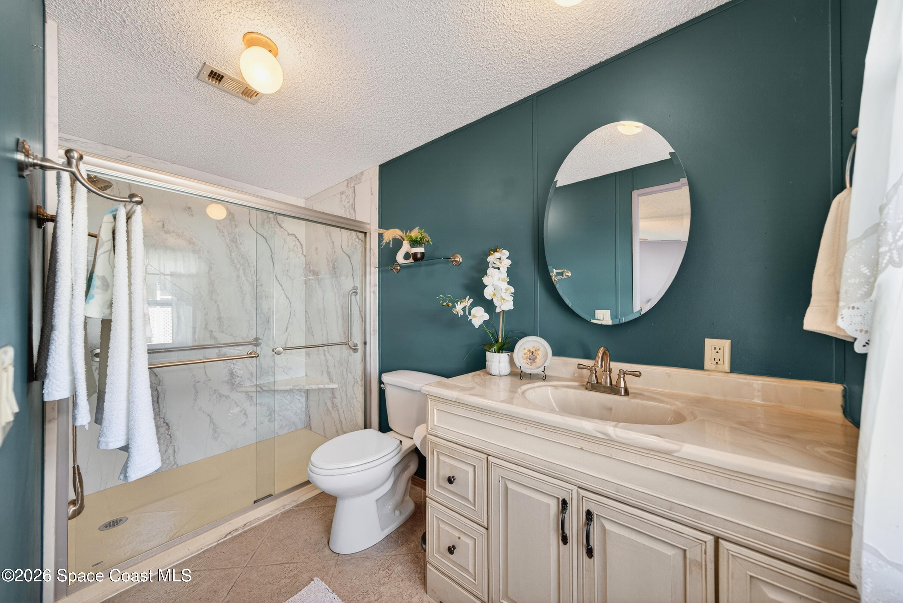 7645 Chasta Road Micco, FL 32976 - Photo 18 of 39 a bathroom with a toilet a sink and a mirror