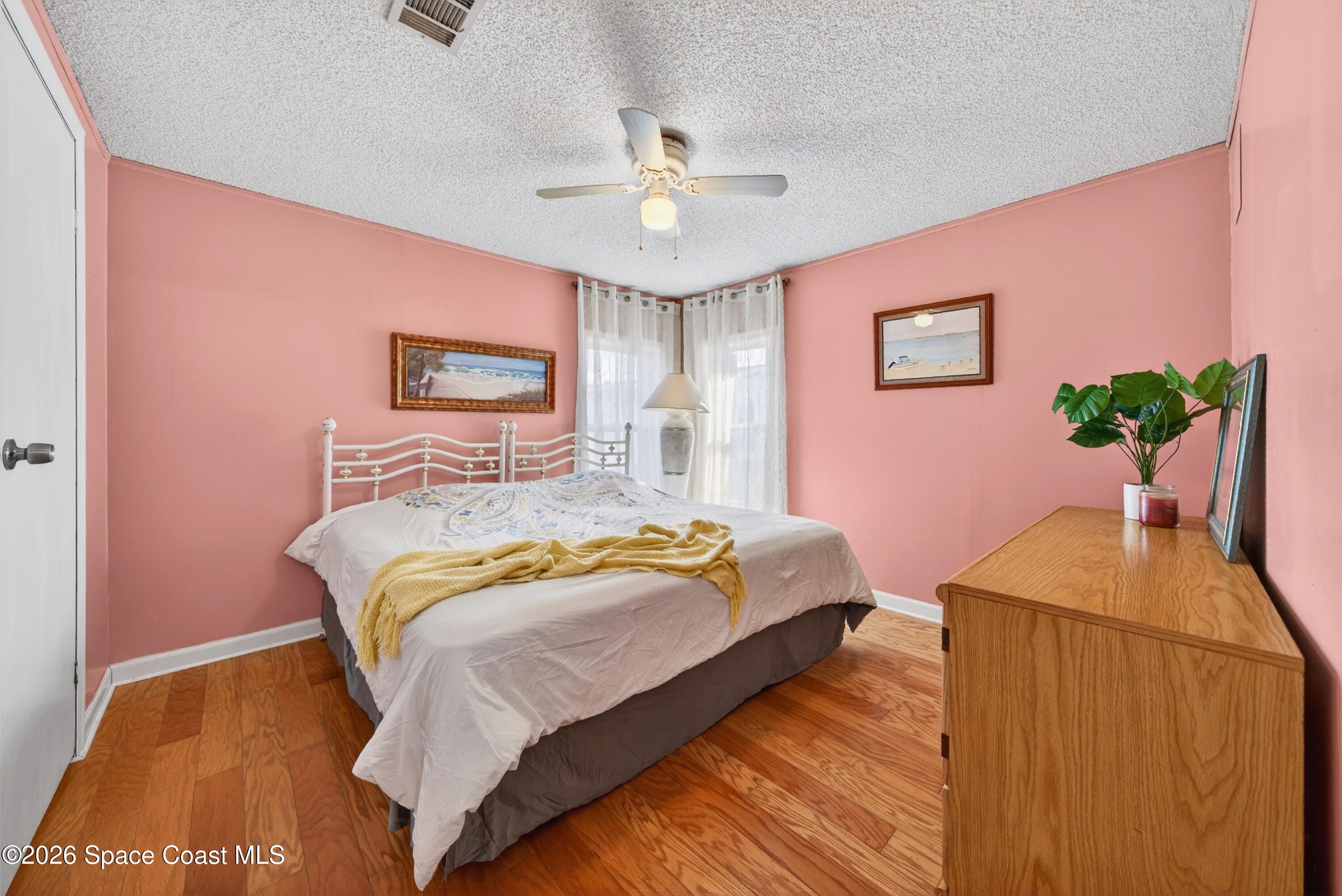 7645 Chasta Road Micco, FL 32976 - Photo 19 of 39 a bedroom with a bed and a chandelier