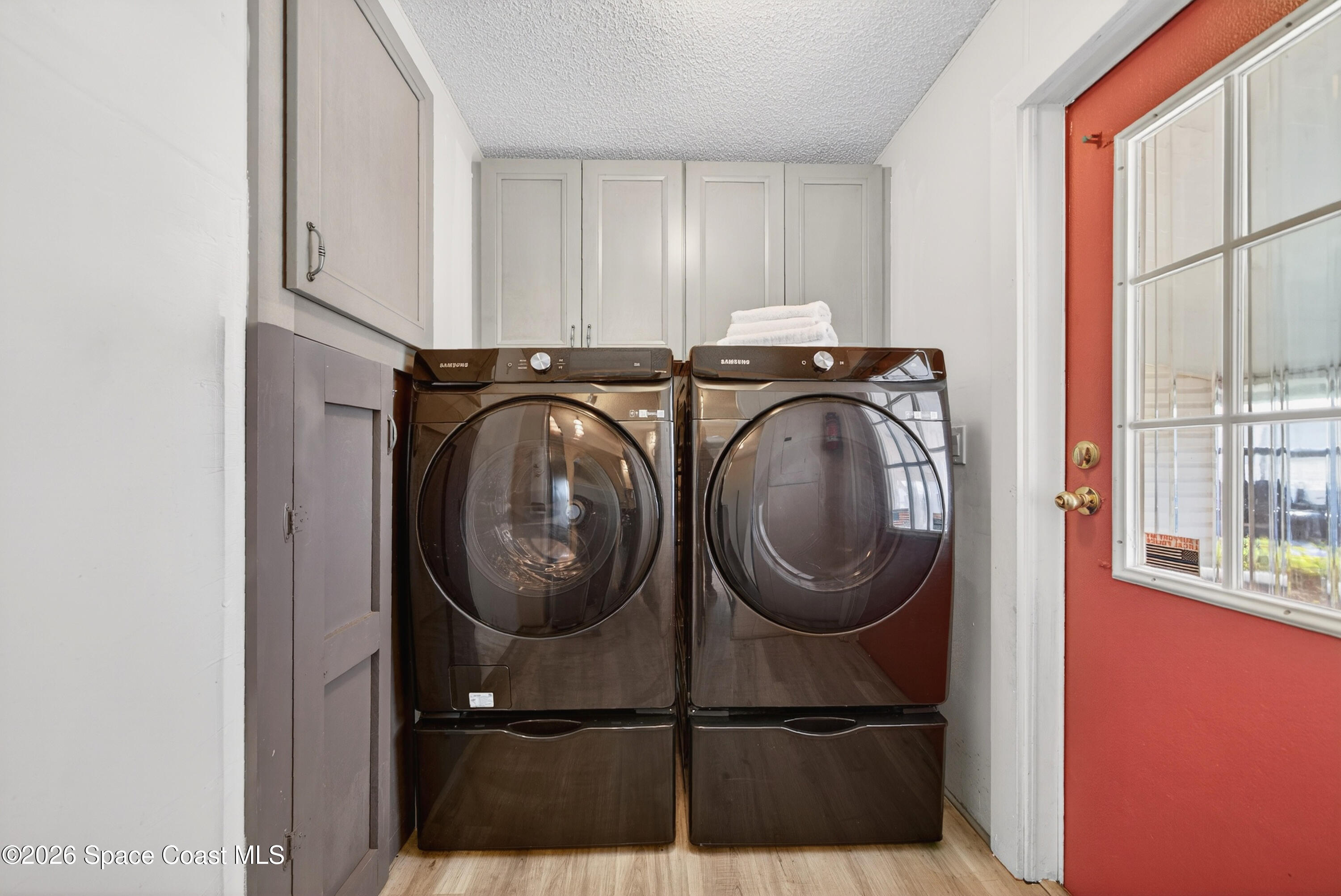 7645 Chasta Road Micco, FL 32976 - Photo 23 of 39 a utility room with dryer and washer