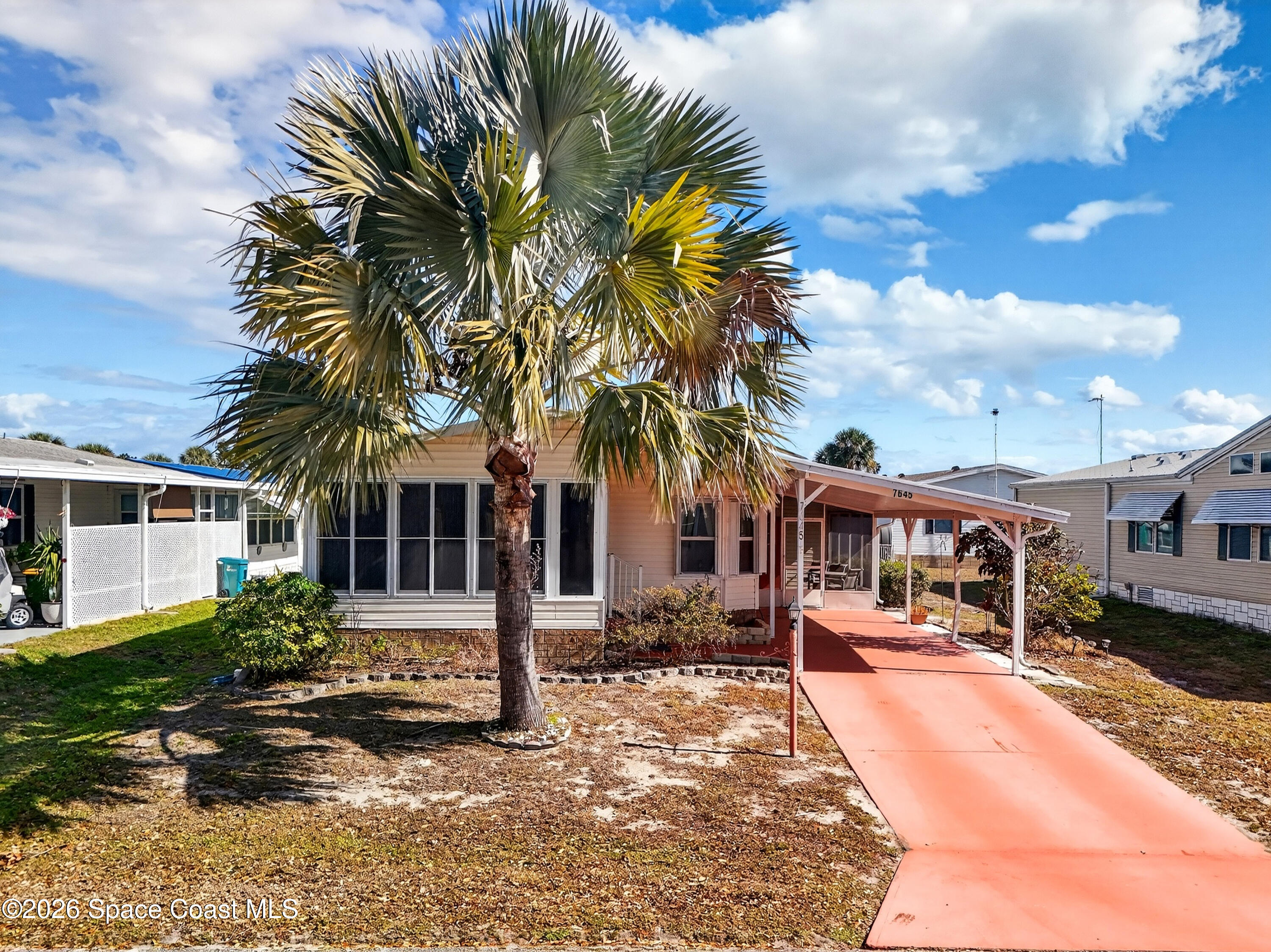 7645 Chasta Road Micco, FL 32976 - Photo 25 of 39 a front view of a house with a yard tree and a yard