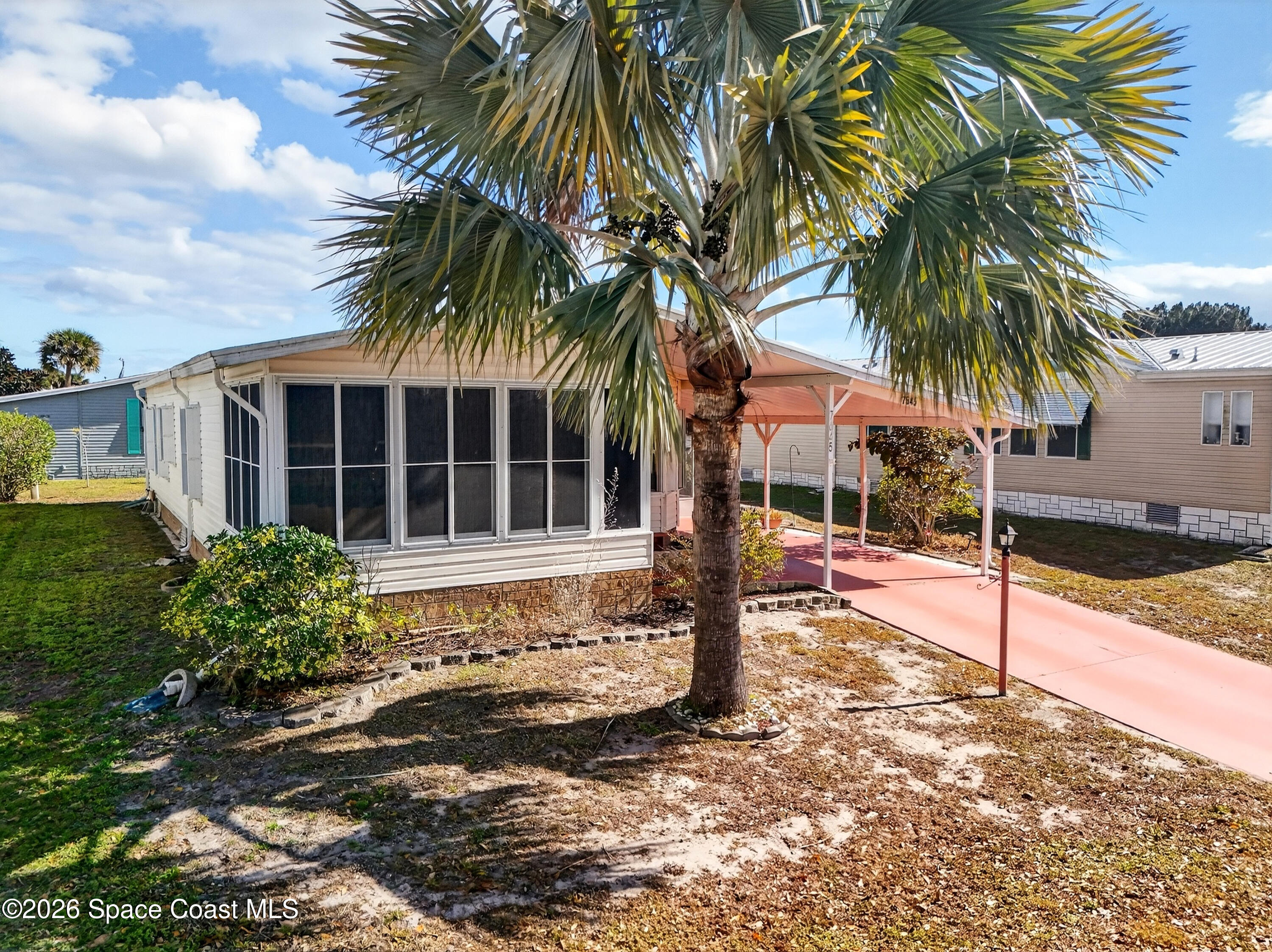 7645 Chasta Road Micco, FL 32976 - Photo 26 of 39 a front view of house with yard and porch