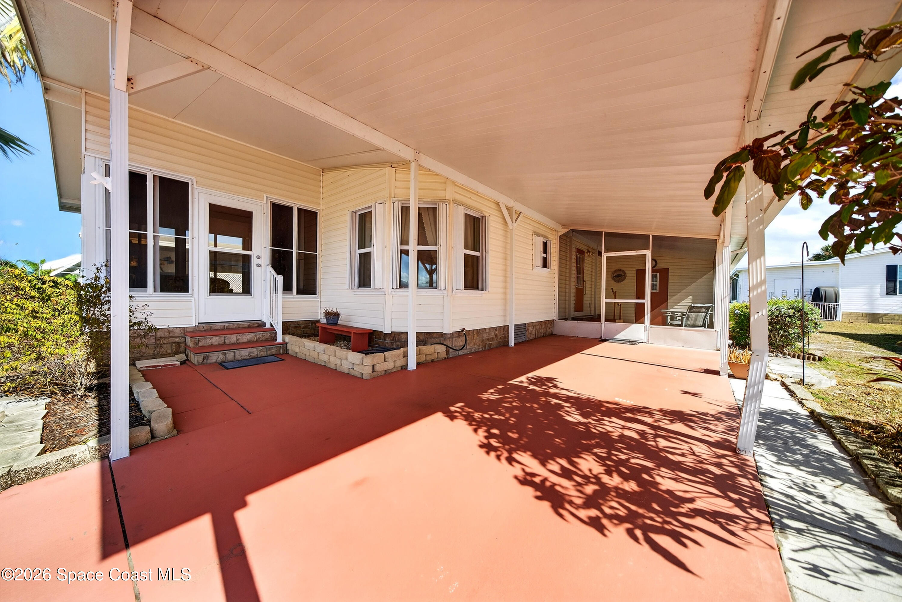 7645 Chasta Road Micco, FL 32976 - Photo 4 of 39 a view of a house with wooden walls and floor to ceiling window