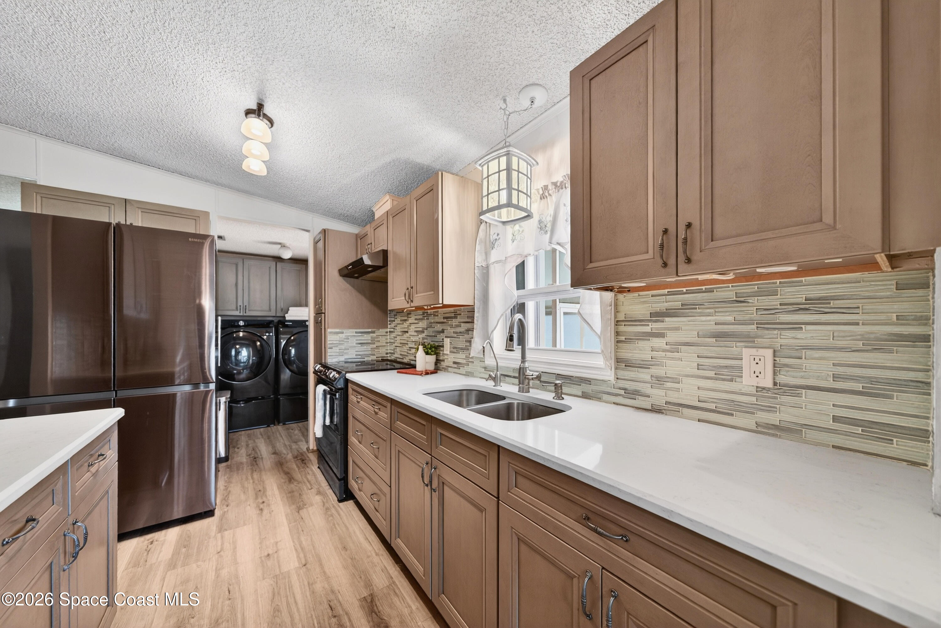 7645 Chasta Road Micco, FL 32976 - Photo 6 of 39 a kitchen with stainless steel appliances granite countertop a sink stove and refrigerator
