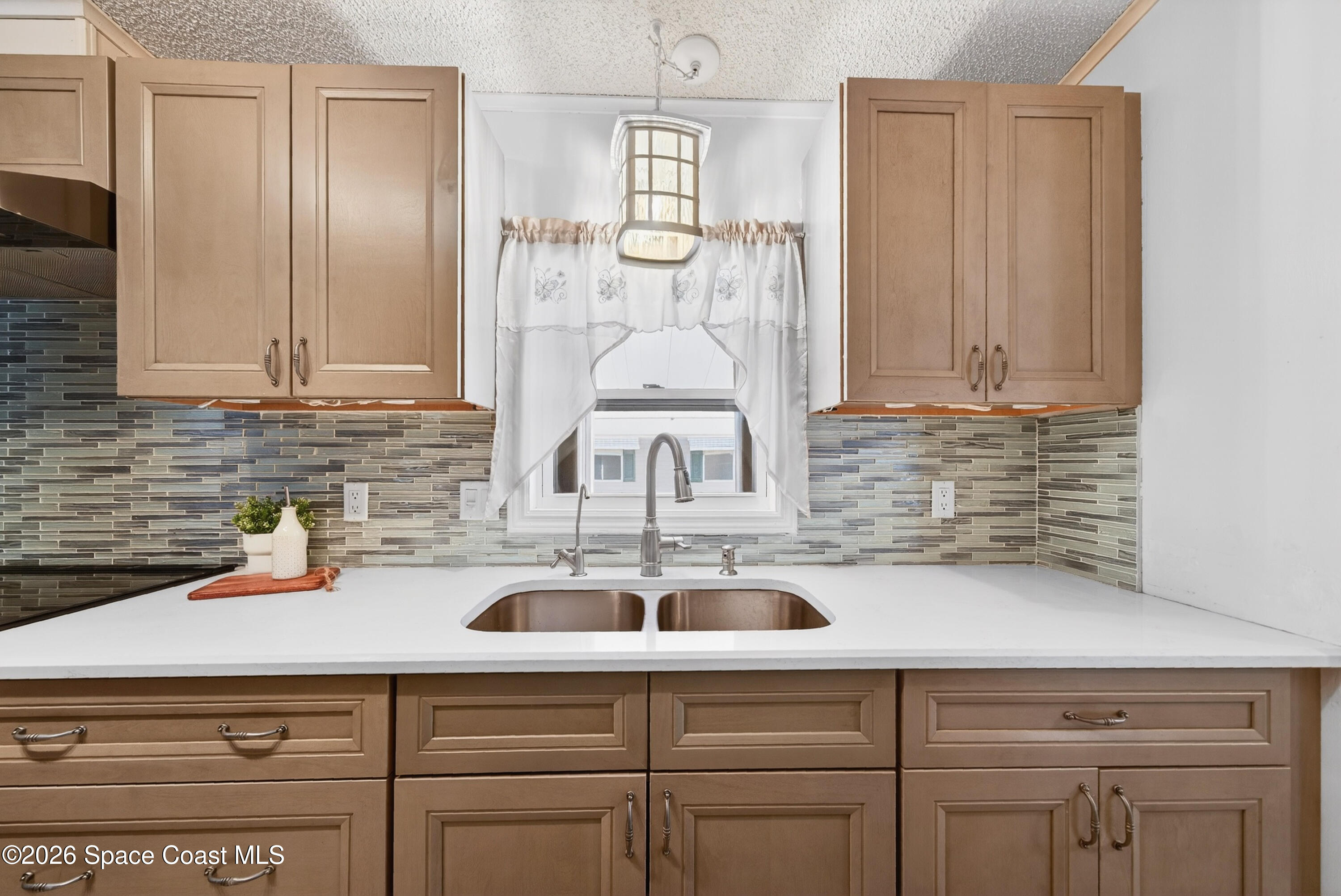 7645 Chasta Road Micco, FL 32976 - Photo 8 of 39 a kitchen with a sink and cabinets