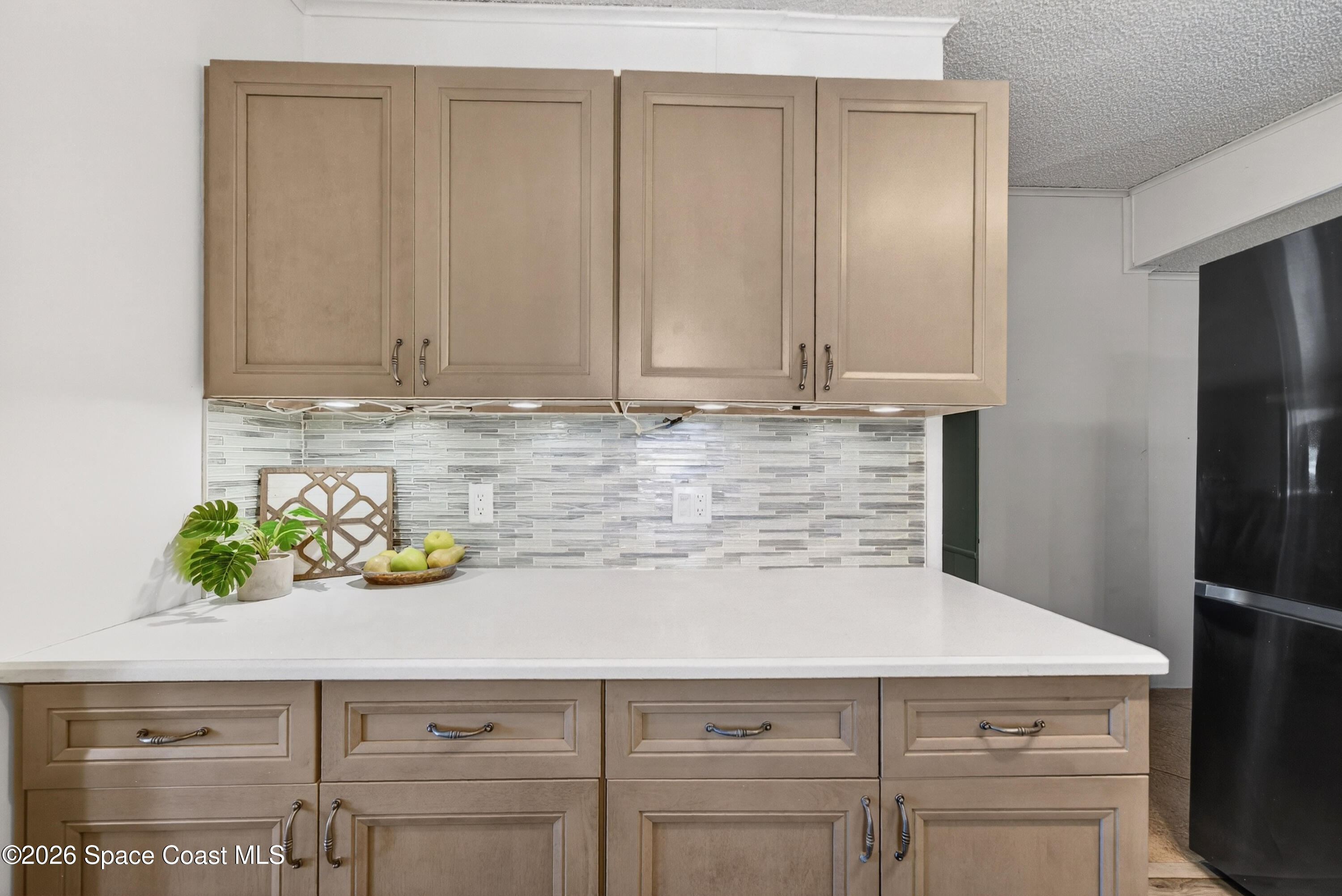 7645 Chasta Road Micco, FL 32976 - Photo 9 of 39 a kitchen with a cabinets and a stove with wooden floor