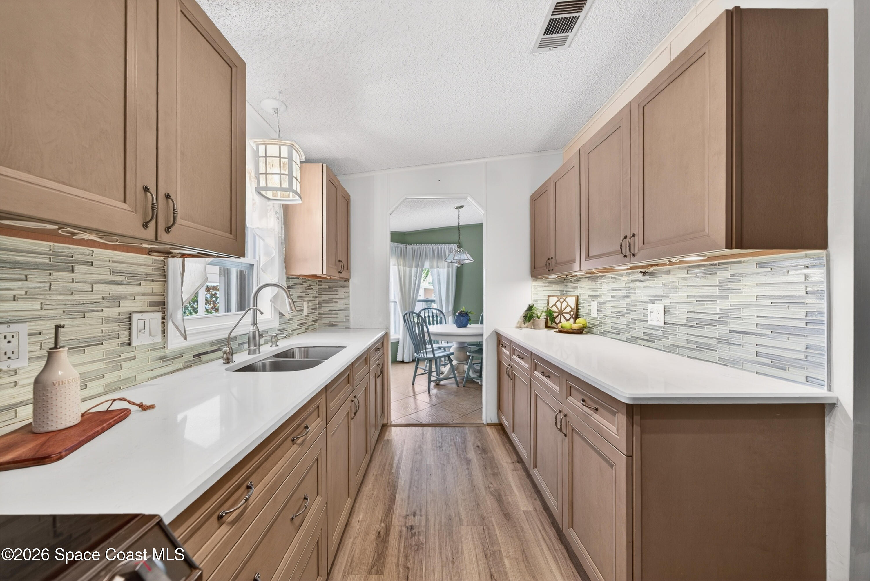 7645 Chasta Road Micco, FL 32976 - Photo 10 of 39 a kitchen with stainless steel appliances granite countertop a sink stove and cabinets