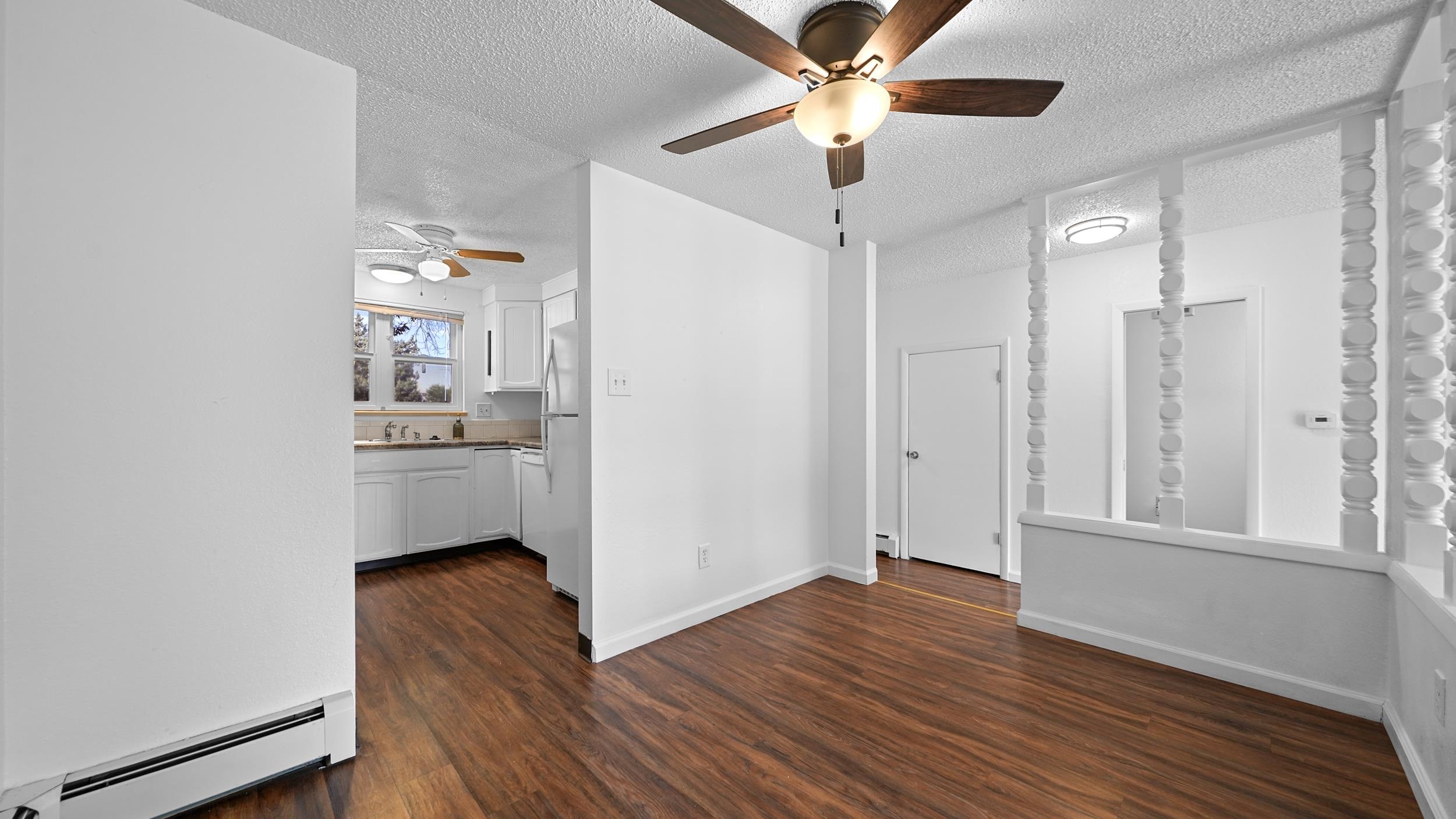 2721 Patterson Road, Unit 903 Grand Junction, CO 81506 - Photo 8 of 22 a view of a kitchen with wooden floor and a ceiling fan