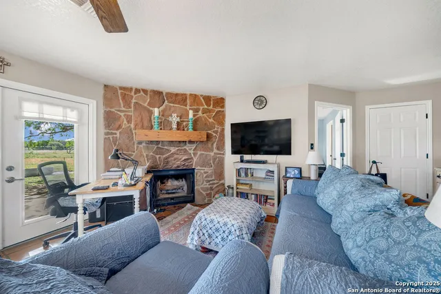 a living room with furniture and a fireplace