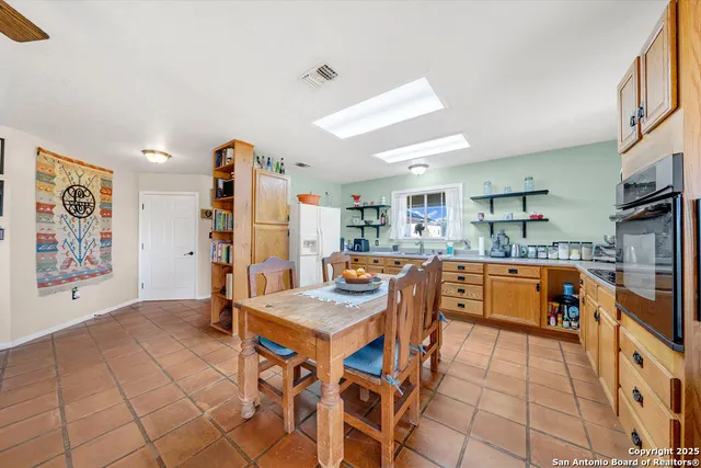 a large kitchen with lots of counter space and windows