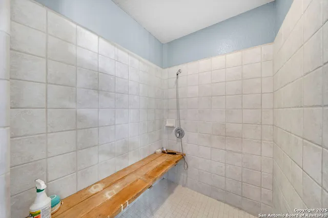 a bedroom with furniture and a large window