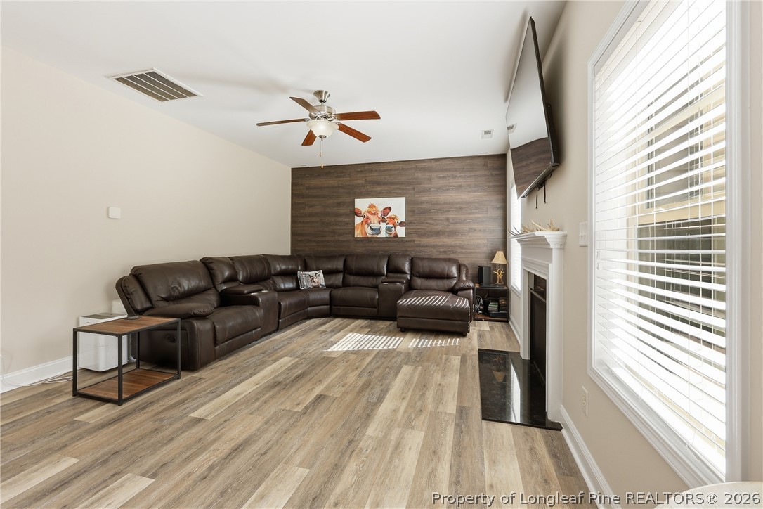 183 Cooper Creek Avenue Spring Lake, NC 28390 - Photo 12 of 34 a living room with furniture and a wooden floor