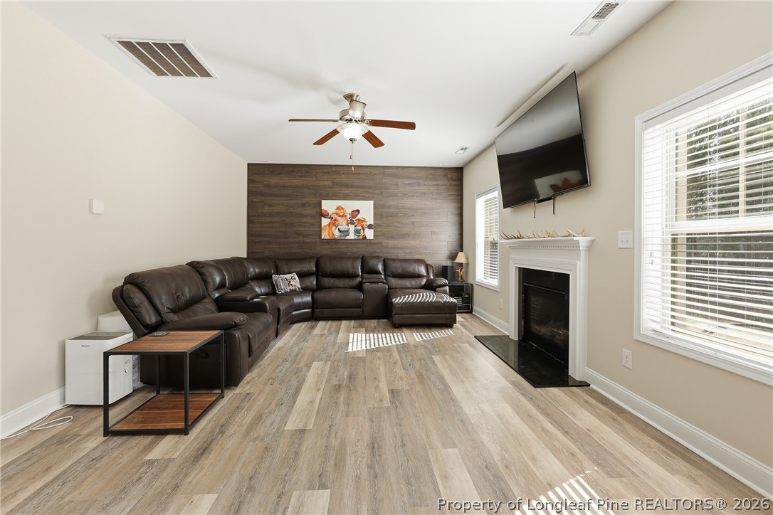 183 Cooper Creek Avenue Spring Lake, NC 28390 - Photo 13 of 34 a living room with furniture a fireplace and a flat screen tv