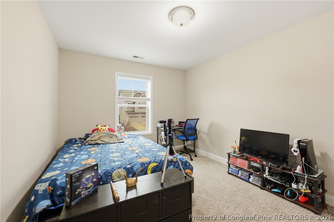 183 Cooper Creek Avenue Spring Lake, NC 28390 - Photo 17 of 34 a bedroom with furniture and a flat screen tv