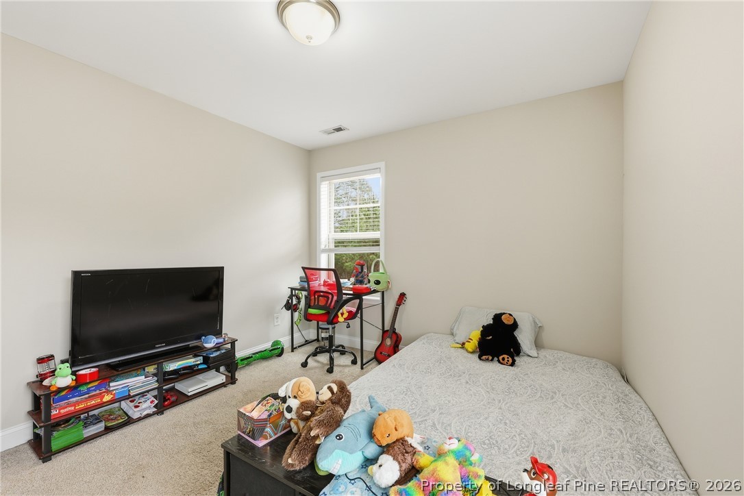 183 Cooper Creek Avenue Spring Lake, NC 28390 - Photo 20 of 34 a room with furniture and a flat screen tv