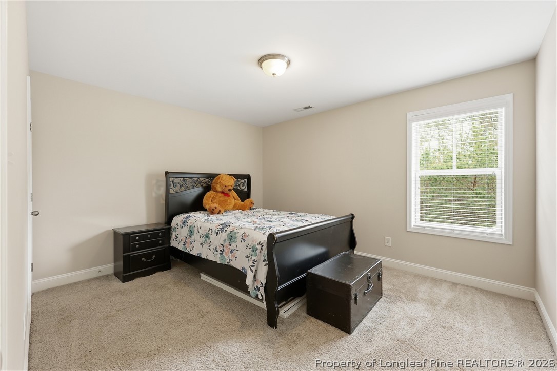 183 Cooper Creek Avenue Spring Lake, NC 28390 - Photo 21 of 34 a bedroom with a bed and a window