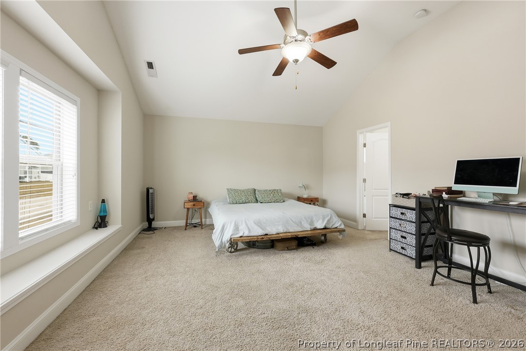 183 Cooper Creek Avenue Spring Lake, NC 28390 - Photo 24 of 34 a spacious bedroom with a bed and a tv