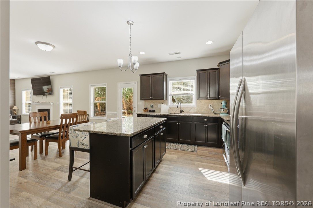 183 Cooper Creek Avenue Spring Lake, NC 28390 - Photo 6 of 34 a large kitchen with kitchen island a sink counter space and stainless steel appliances
