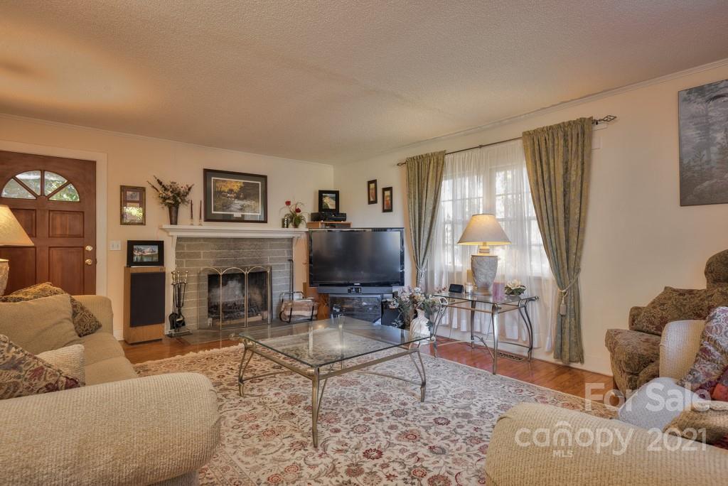 197 Turner Road Tryon, NC 28782 - Photo 23 of 45 a living room with furniture a large window and a fireplace