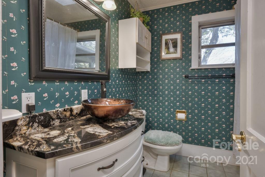 197 Turner Road Tryon, NC 28782 - Photo 34 of 45 a bathroom with a sink a toilet and mirror