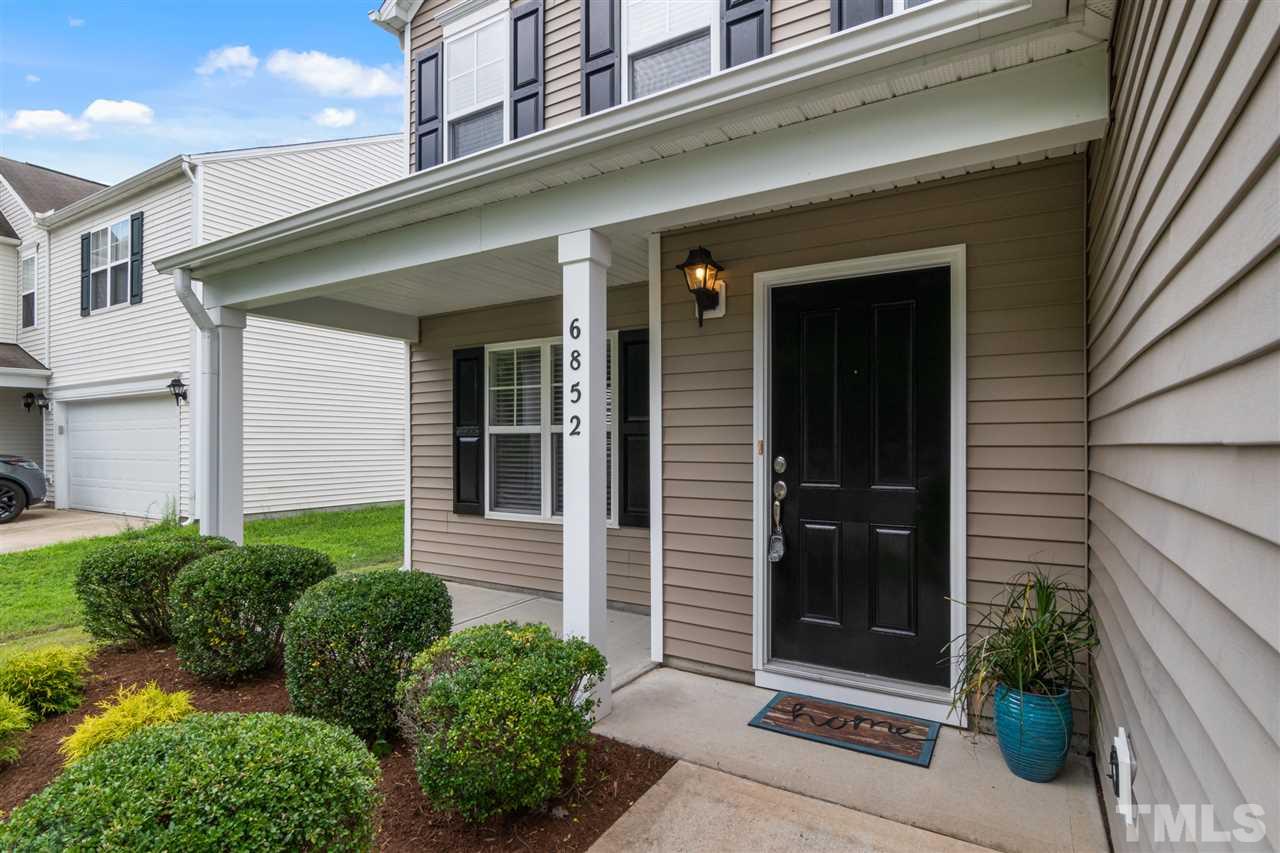 6852 Harter Court Raleigh, NC 27610 - Photo 2 of 29 a view of a house door with a potted plant in front of door
