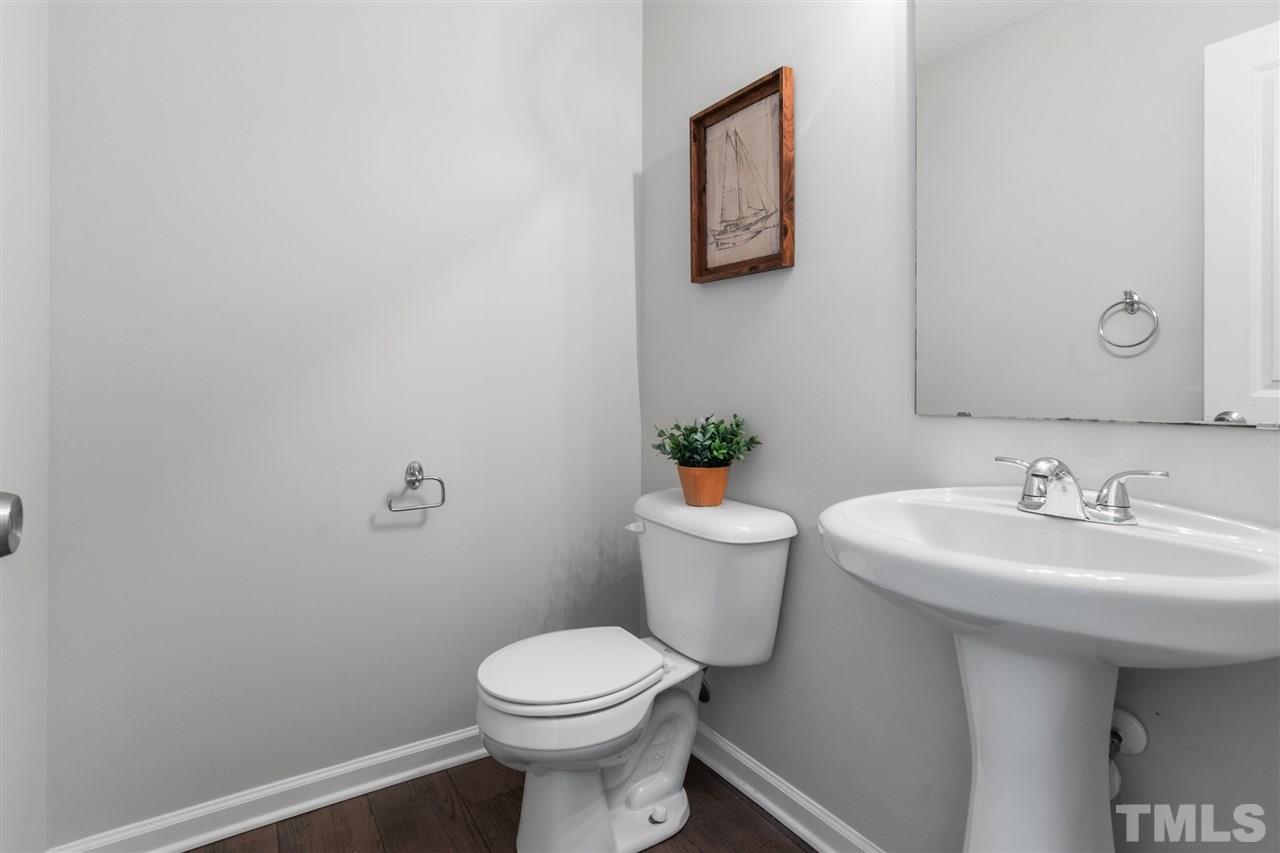 6852 Harter Court Raleigh, NC 27610 - Photo 13 of 29 a bathroom with a sink and a toilet