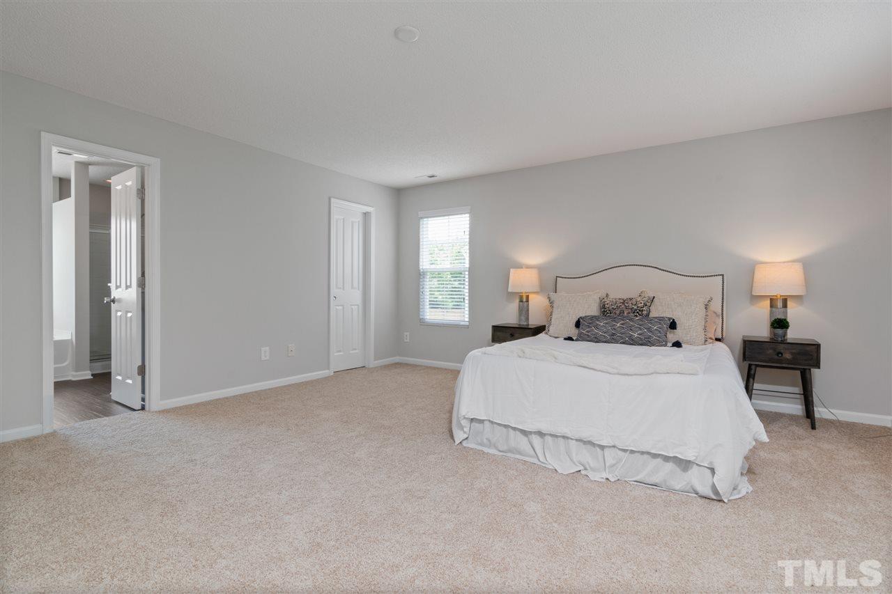 6852 Harter Court Raleigh, NC 27610 - Photo 14 of 29 a bedroom with a bed and window