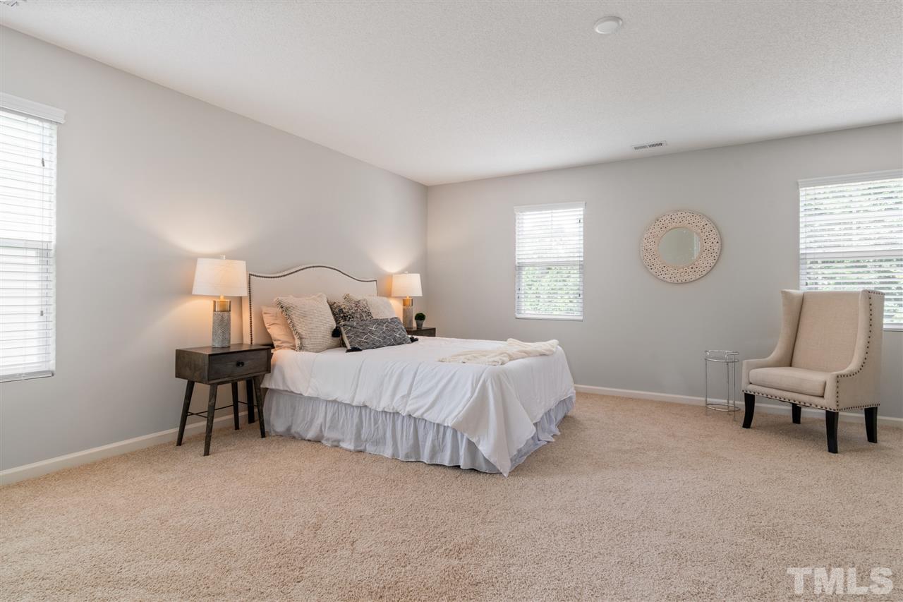 6852 Harter Court Raleigh, NC 27610 - Photo 15 of 29 a bedroom with a bed chair and window