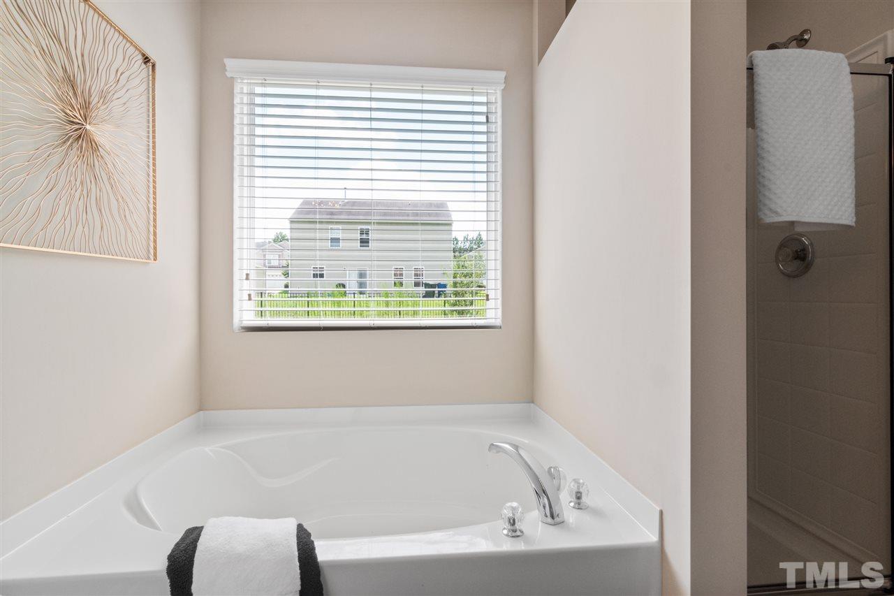 6852 Harter Court Raleigh, NC 27610 - Photo 17 of 29 a white bath tub sitting next to a window