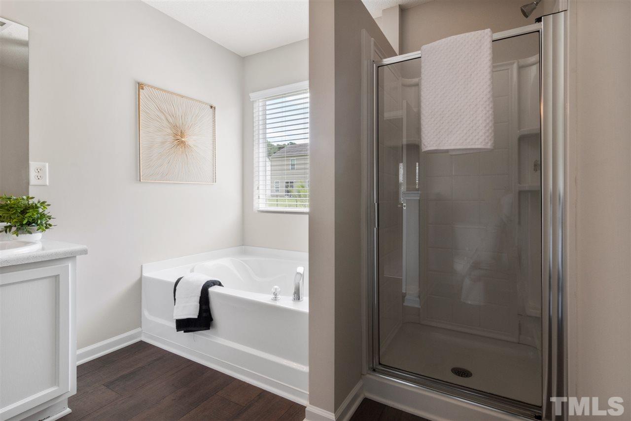 6852 Harter Court Raleigh, NC 27610 - Photo 18 of 29 a bathroom with a bathtub and a shower