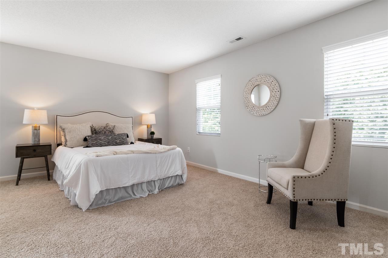 6852 Harter Court Raleigh, NC 27610 - Photo 20 of 29 a bedroom with a bed chair and window