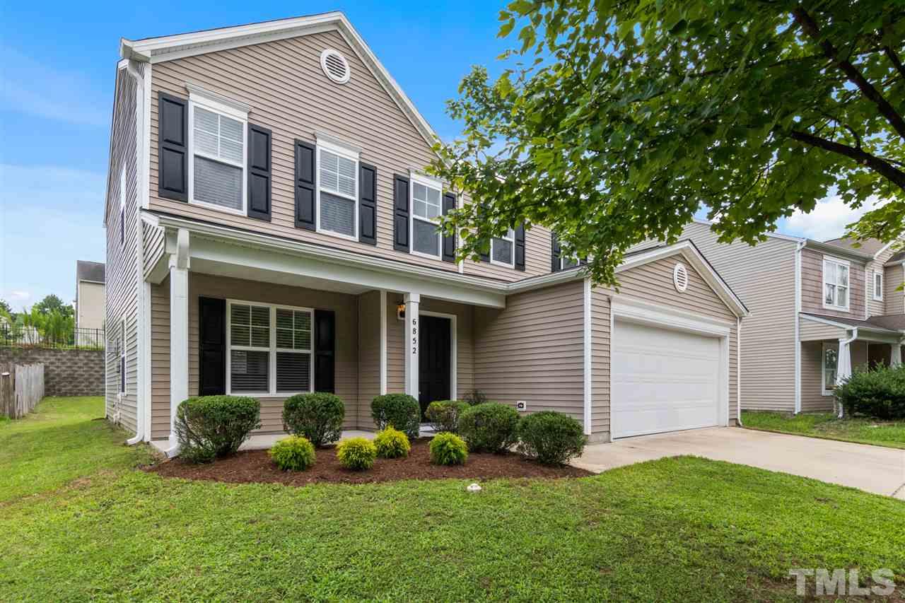 6852 Harter Court Raleigh, NC 27610 - Photo 27 of 29 a front view of a house with a yard and garage