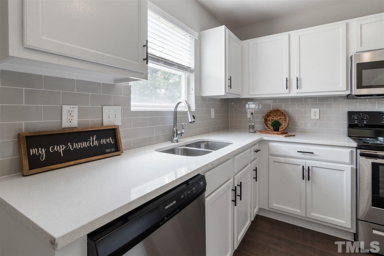 6852 Harter Court Raleigh, NC 27610 - Photo 8 of 29 a kitchen with a sink cabinets and window
