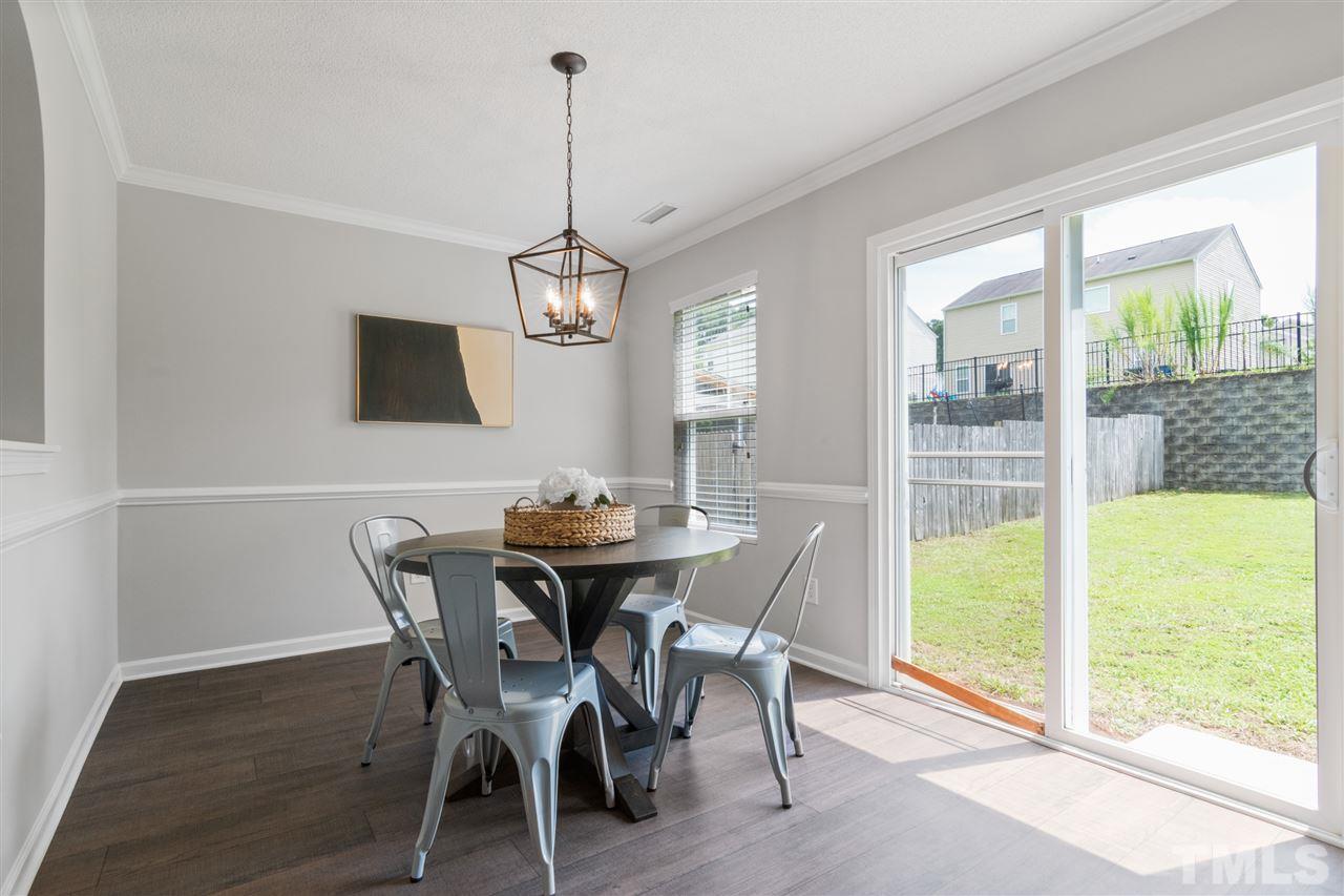 6852 Harter Court Raleigh, NC 27610 - Photo 10 of 29 a view of a dining room with furniture window and wooden floor