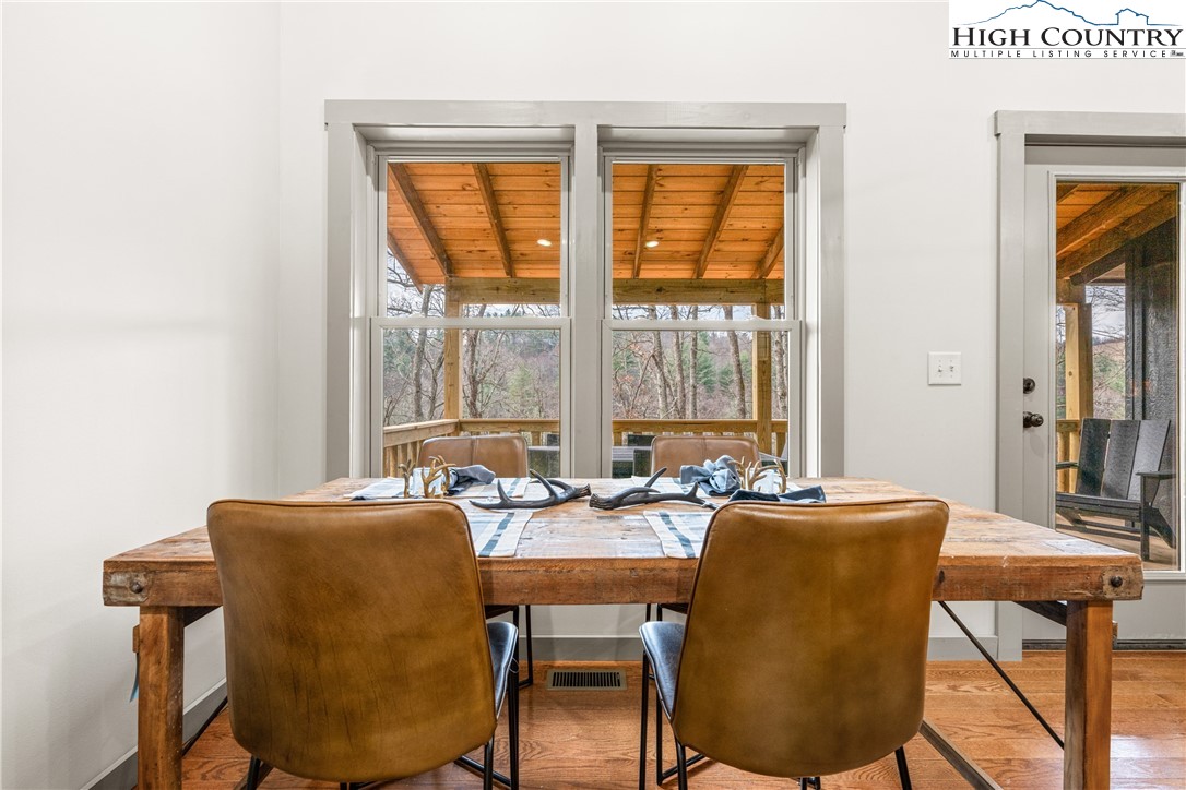 214 Ridge Run Road West Jefferson, NC 28694 - Photo 15 of 49 a dining room with furniture and a floor to ceiling window