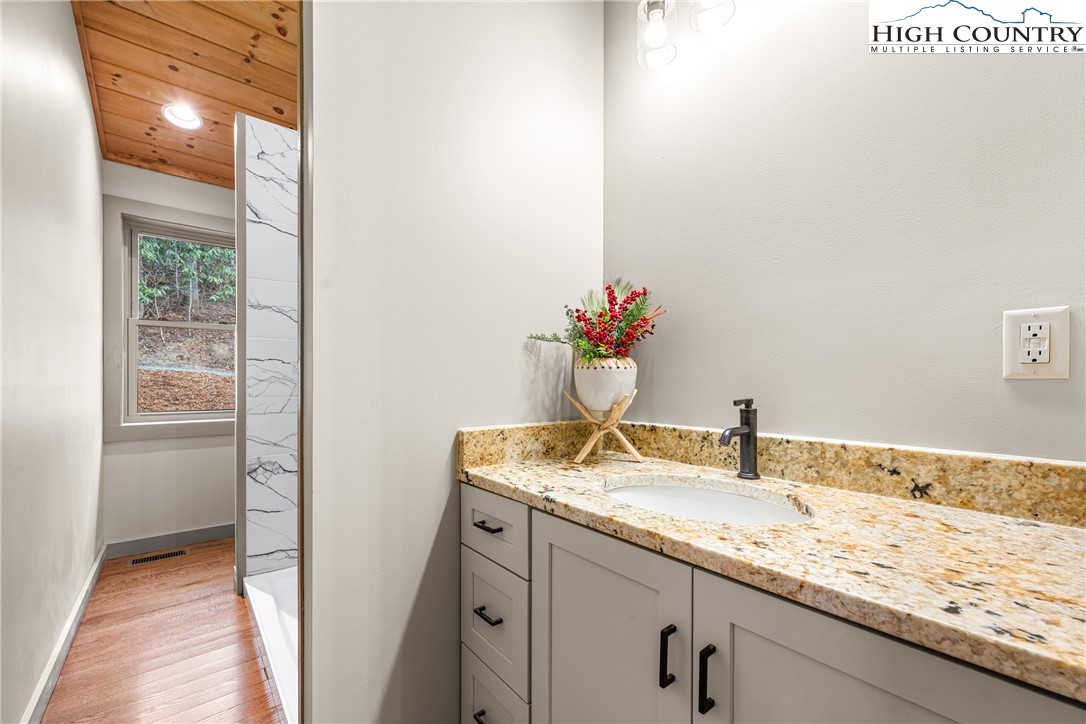 214 Ridge Run Road West Jefferson, NC 28694 - Photo 17 of 49 a bathroom with a granite countertop sink and a mirror
