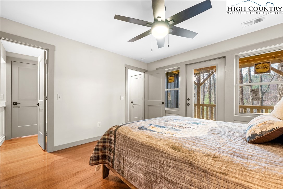214 Ridge Run Road West Jefferson, NC 28694 - Photo 27 of 49 a bedroom with a bed chandelier and a window