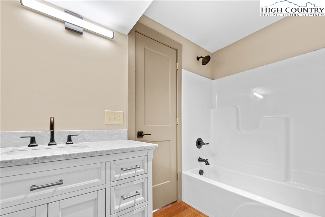 214 Ridge Run Road West Jefferson, NC 28694 - Photo 28 of 49 a bathroom with a bathtub shower sink and vanity
