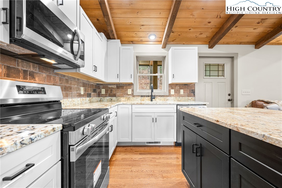 214 Ridge Run Road West Jefferson, NC 28694 - Photo 8 of 49 a kitchen with a sink stove and cabinets