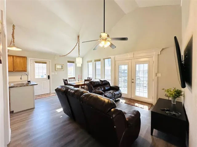 a living room with furniture flat screen tv and window