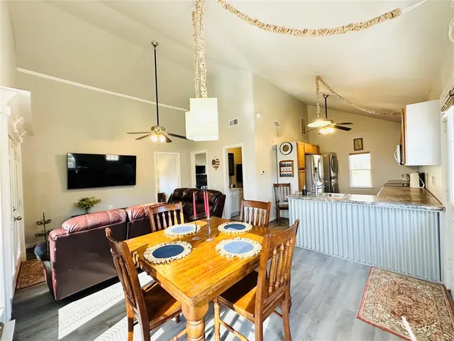 a dining room with furniture and a flat screen tv